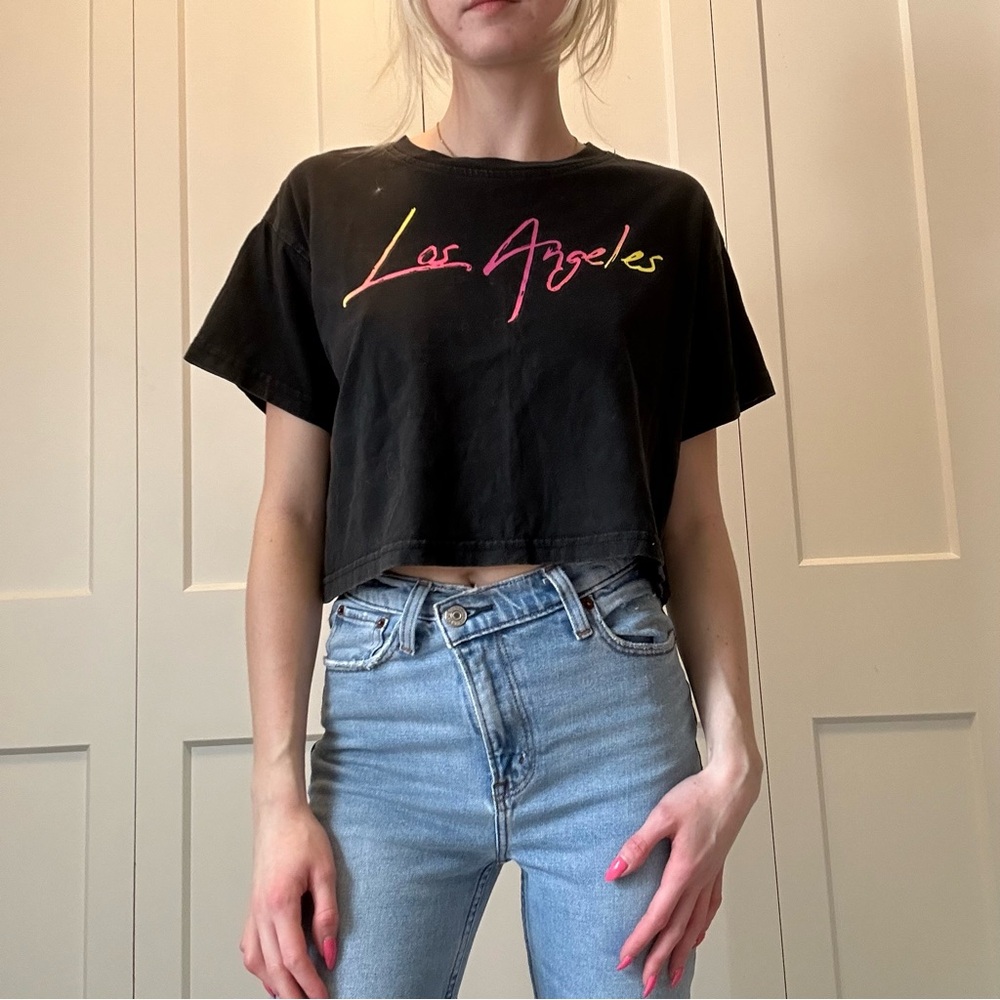 Black, cropped, short sleeve t-shirt, with colorful neon “Los Angeles” lettering